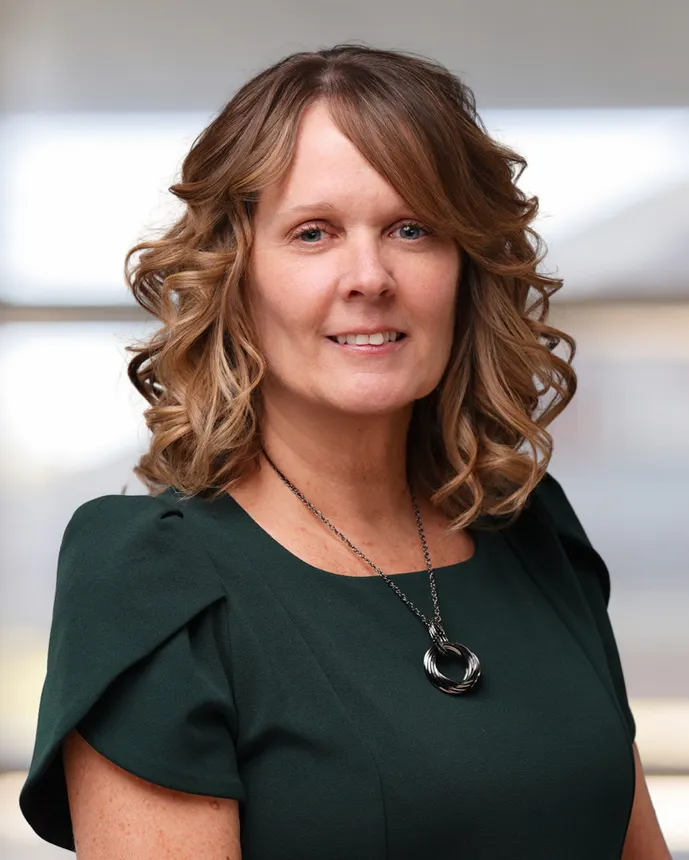 Headshot of a woman in business attire.