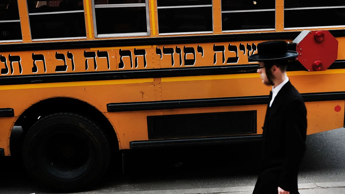 A Hasidic man walks through a Jewish Orthodox neighborhood in Brooklyn on April 24, 2017 in New York City.