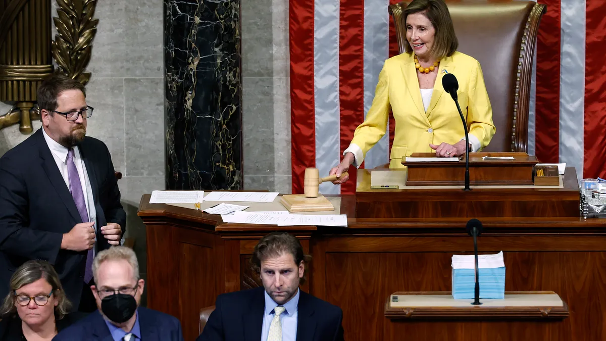 Nancy Pelosi bangs a gavel in the House chamber