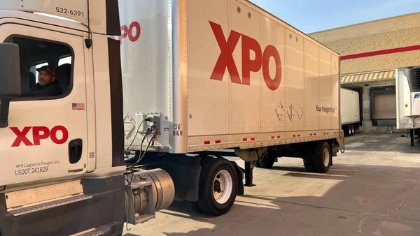 XPO driver Steadman "Steve" Mitchell reverses his truck toward a loading dock at a Costco in Elkridge.