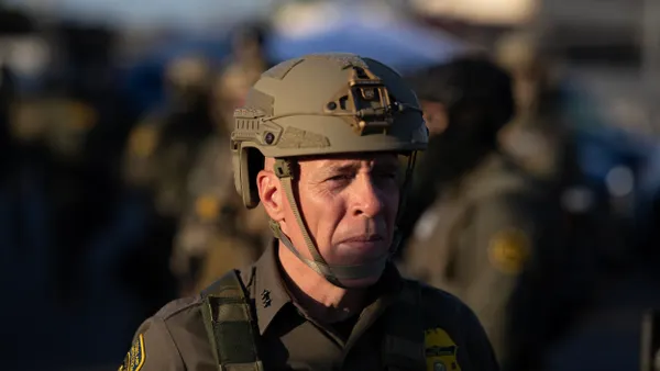A man wearing military fatigues and a helmet