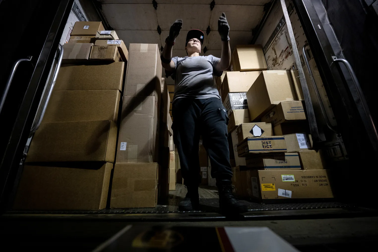 Lana Provost, a UPS package handler, loads packages into a truck at the UPS Centennial Ground Hub on December 6, 2021 in Louisville, Kentucky.