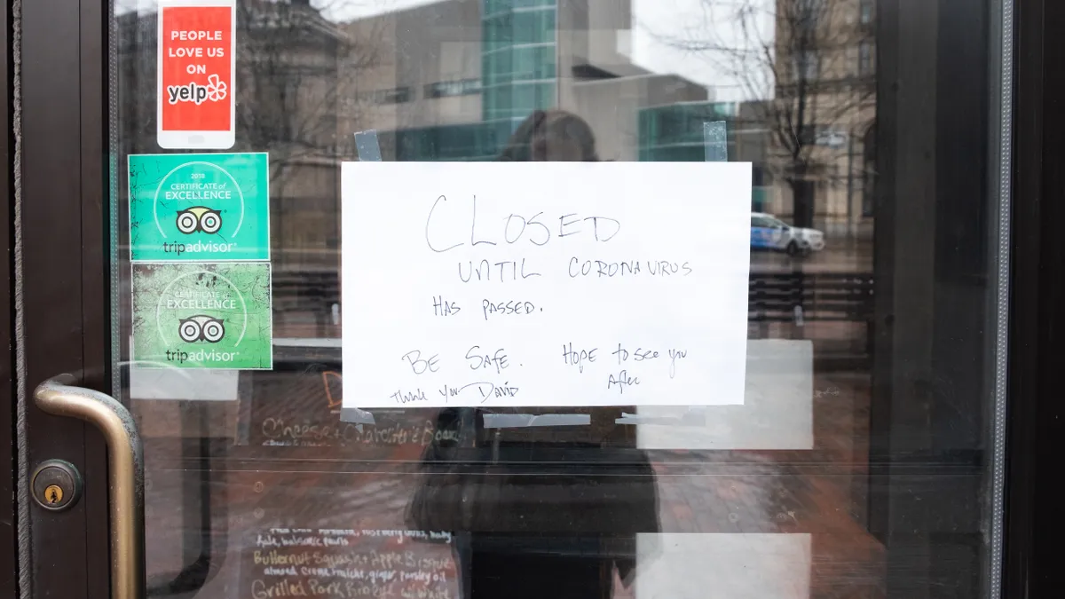 A small business in Portland, Maine posts a sign to customers after voluntarily shuttering during the COVID-19 pandemic.