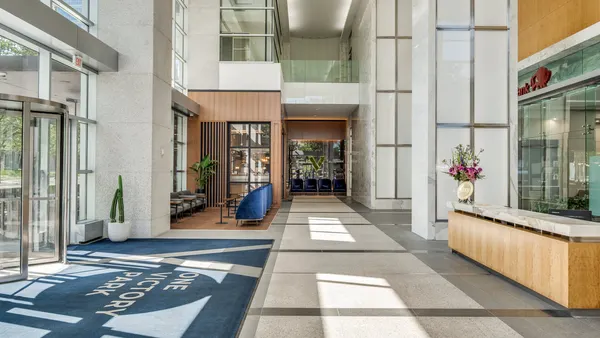 The interior of a modern office lobby.