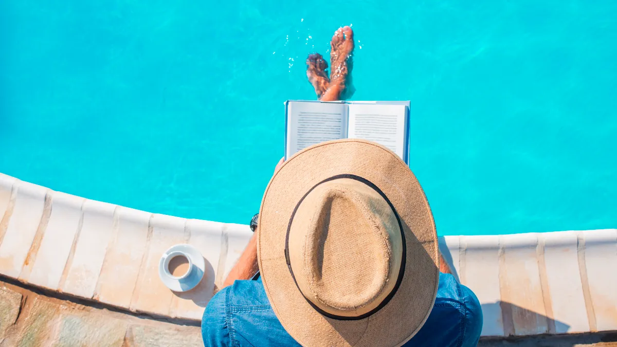 Man reading by the pool