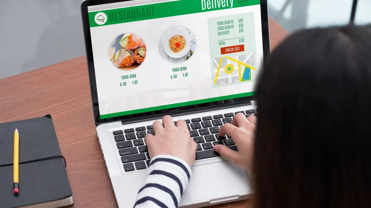 An image of a woman making an online order for a restaurant.