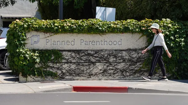 A woman walks in front of a sign by a Planned Parenthood health center on June 26, 2025 in San Rafael, California.