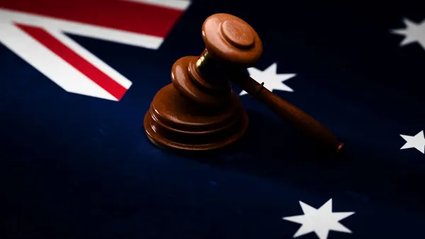 Gavel sitting on top of textured Australian flag