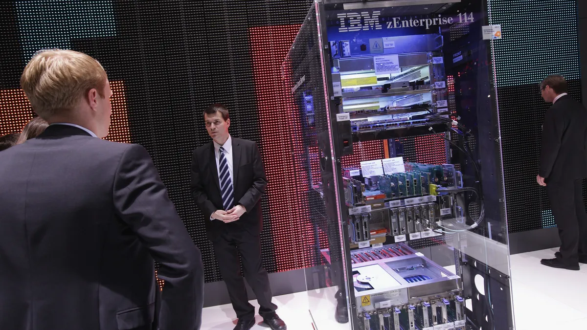 A stand host explains a zEnterprise 114 high-performance mainframe at the IBM stand on the first day of the CeBIT 2012 technology trade fair on March 6, 2012 in Hanover, Germany.