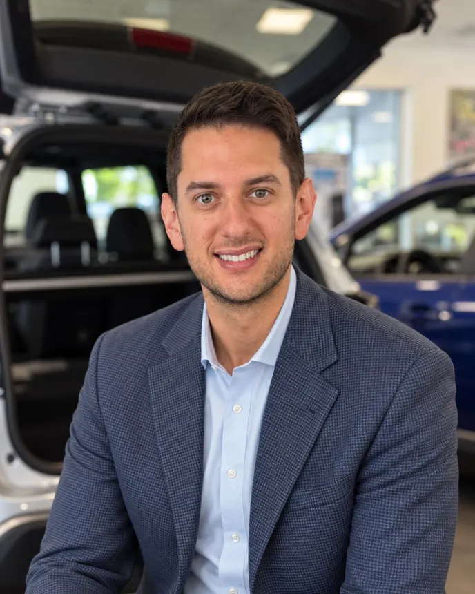 A man in a suit poses for a picture.