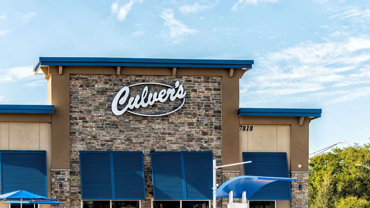 A photograph of a beige brick building with a sign that says Culver's