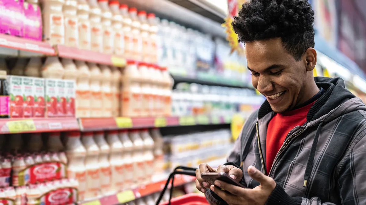 Customer buying with mobile app at supermarket.