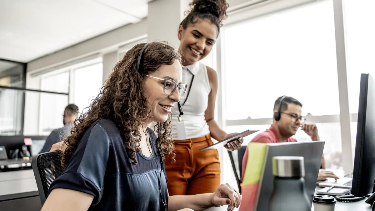 Call center manager instructing employees.