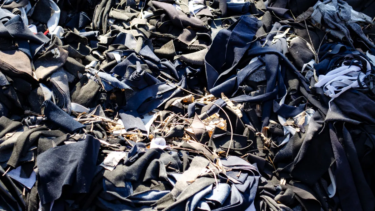 A pile of textile scraps strewn on the ground.