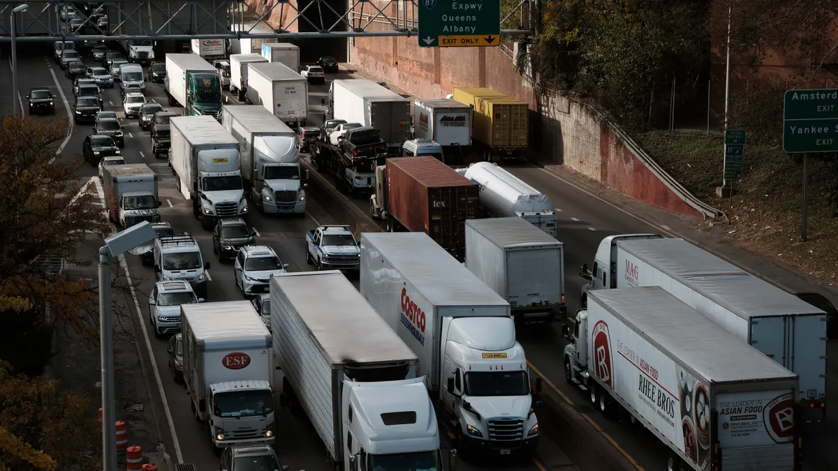 An overhead view of the six-lane Cross Bronx Expressway filled with bumper-to-bumper cars and large trucks.