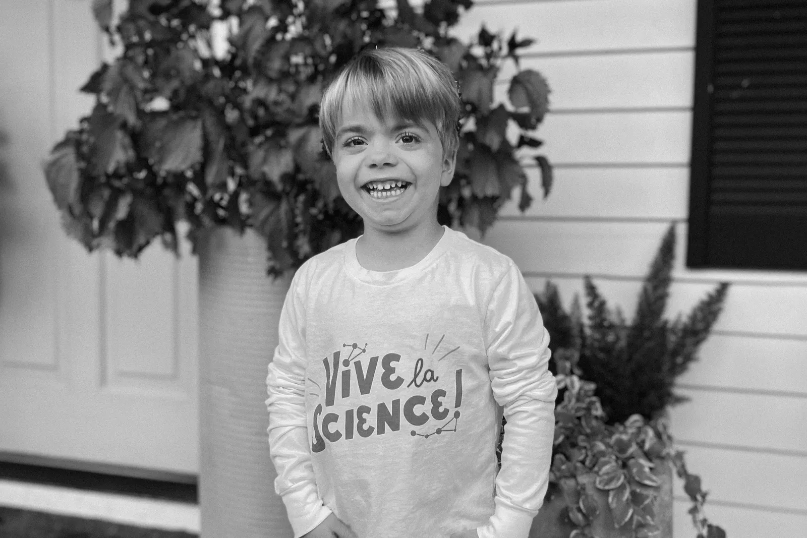 A young boy is seen smiling for a photograph