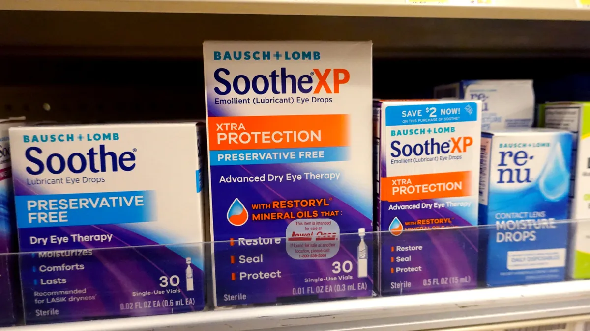 Boxes on a store shelf say "Soothe XP," showing eye drops for dry eye therapy.