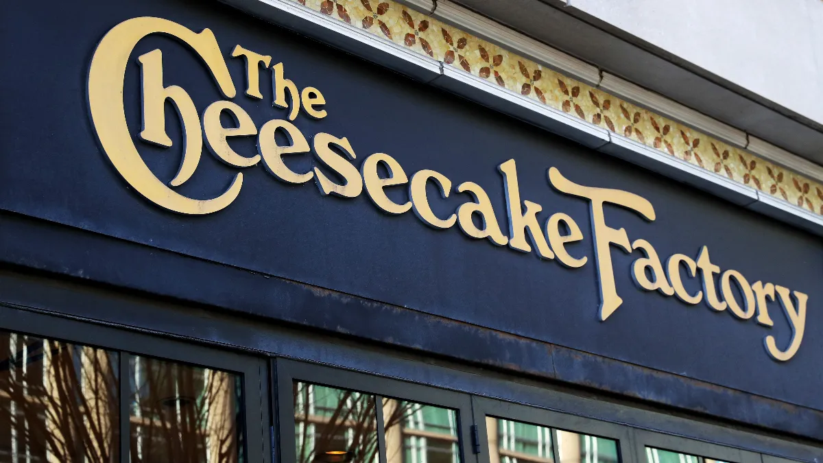 An image of a black building with windows and The Cheesecake Factory signage.