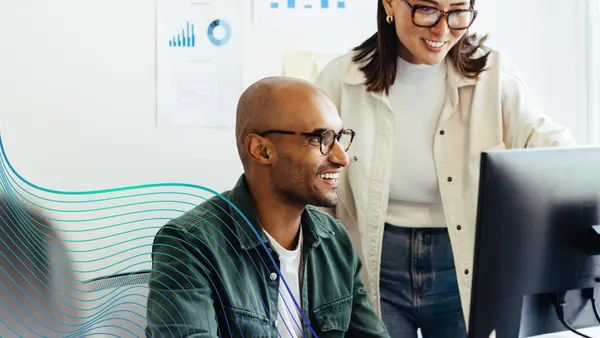 two people looking at computer