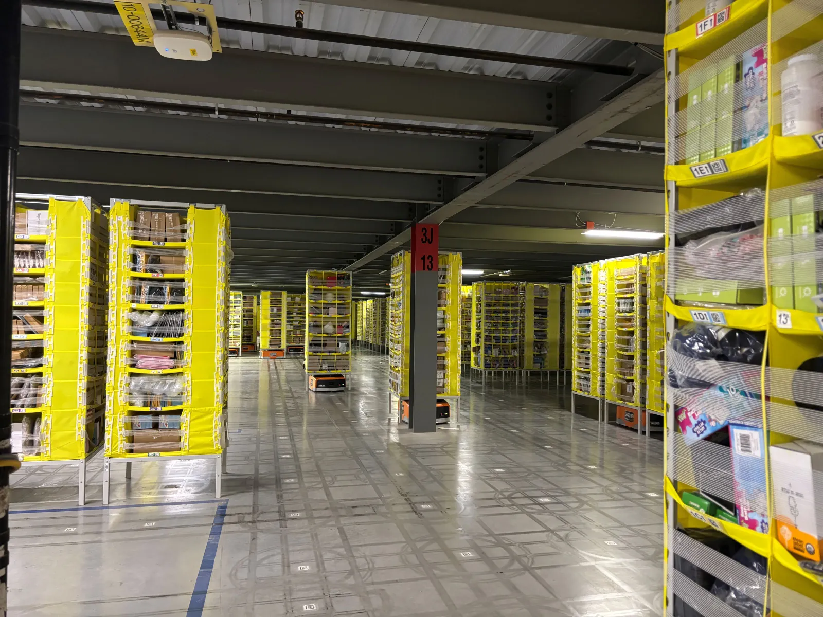 Inventory sits on yellow shelves in a warehouse.