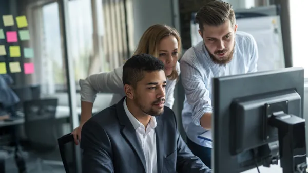 Business colleagues working together on a computer in an office.