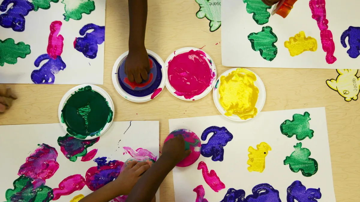 Young children work on a paint project at the 4 Kids Early Learning Center in Braddock, Pennsylvania.