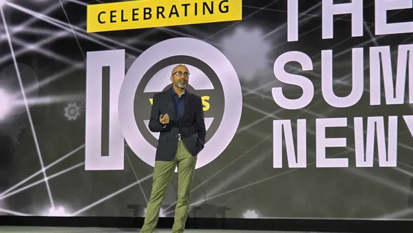 An executive on stage in business attire