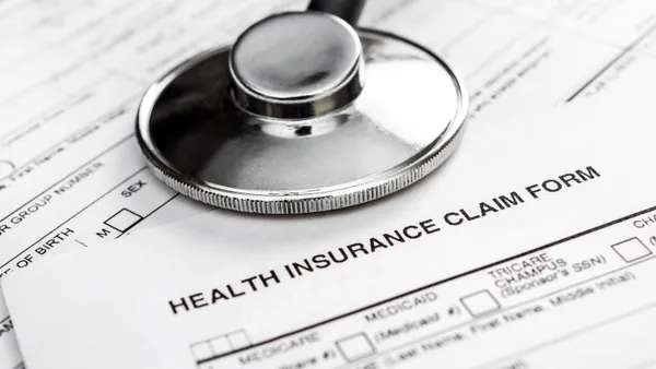 A stethoscope rests on a medical insurance claim form.