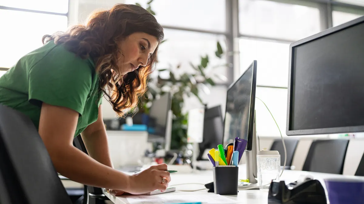 Professional Woman Working at a Modern Office Desk During Daytime