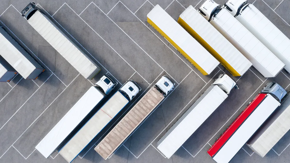 Heavy goods transportation - trucks in truck stop from above.