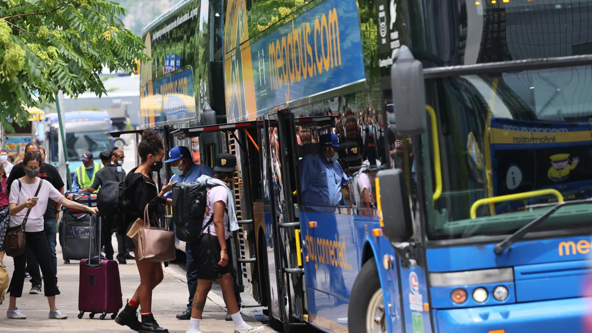 People line up to board a double-decker Megabus.