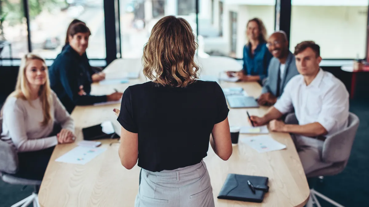 A businesswoman addressing a meeting in office