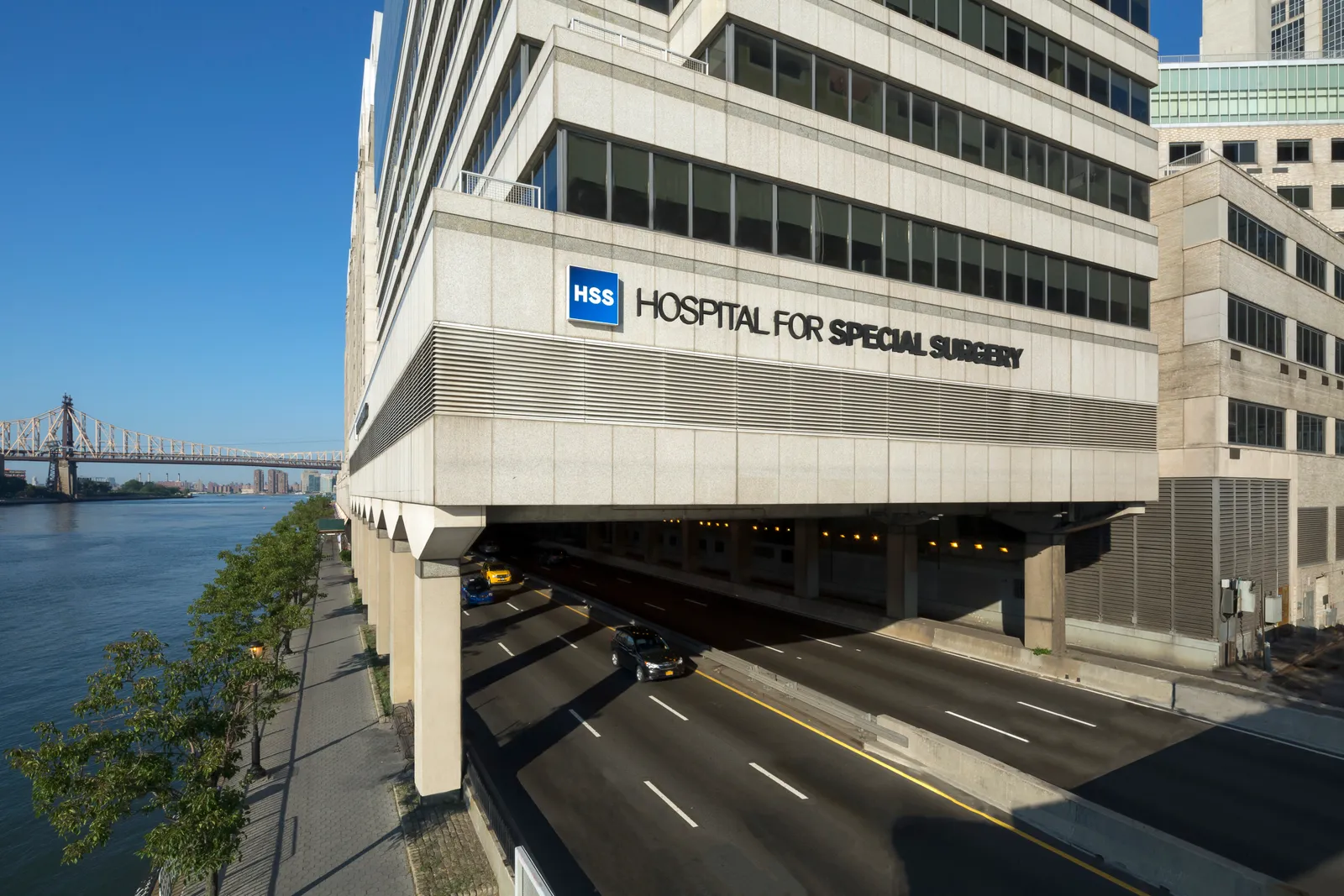 Exterior of a building with a road under it that says &quot;Hospital for Special Surgery&quot;