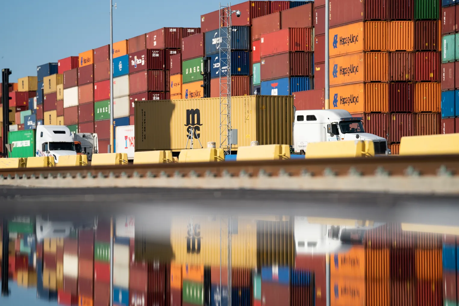 Trucks pass stacks of empty containers at the Garden City Port Terminal on November 12, 2021 in Garden City, Georgia.