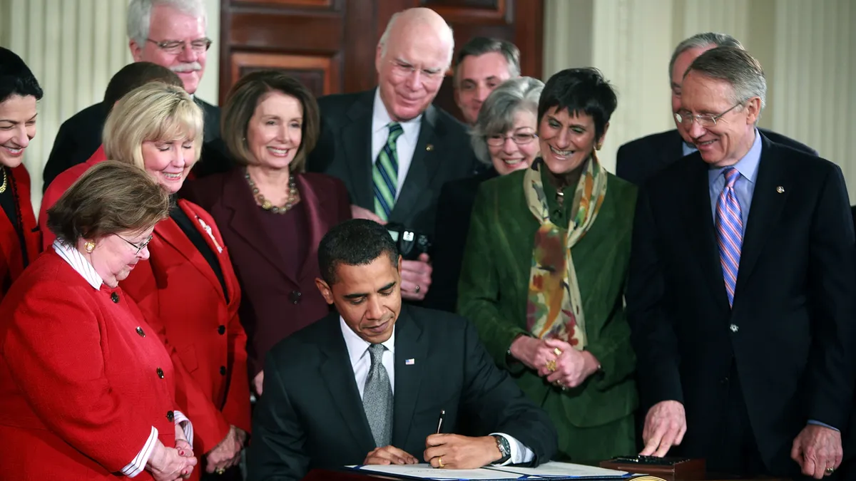 President Barack Obama signs the Lilly Ledbetter Fair Pay Act.