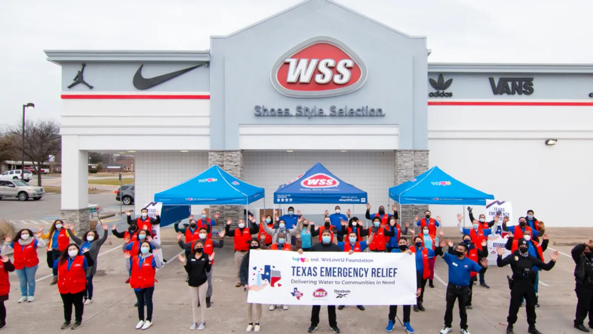 Employees stand in front of a WSS location.