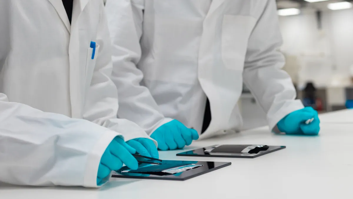 Northvolt engineers inspect a sodium ion battery sample.