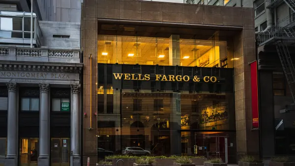 A Wells Fargo & Co. bank branch with a modern glass façade is situated between older buildings, including one labeled "Montgomery Plaza.