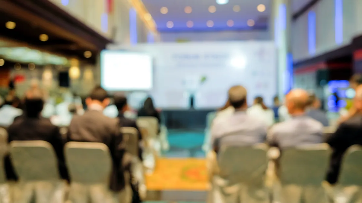 A blurred photo of a conference hall.