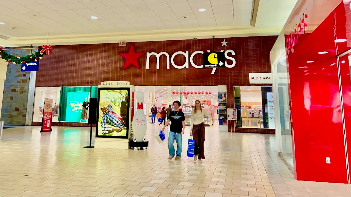 People walking in a mall near a Macy's department store at the holidays