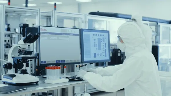 A scientist uses Rockwell Automation's PharmaSuite software in a lab.