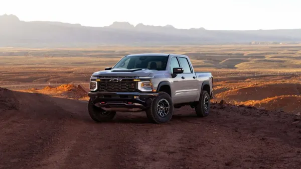 A 2027 Chevrolet Silverado 1500 ZR2 in painted in White Sands parked on a dirt trail.