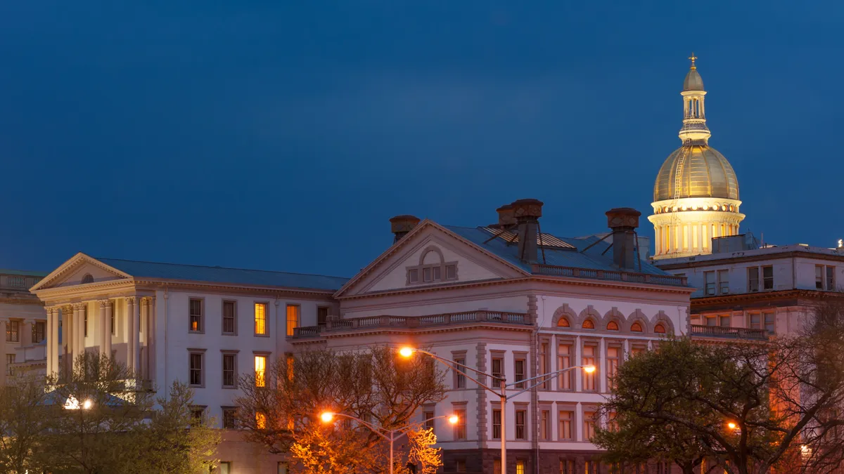 A dome lit up in gold contrasts with the night sky.