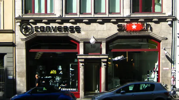 A stone building with a Converse storefront on the street level.
