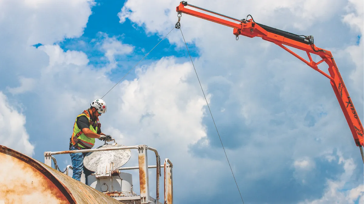 Construction worker working on site with a crane.