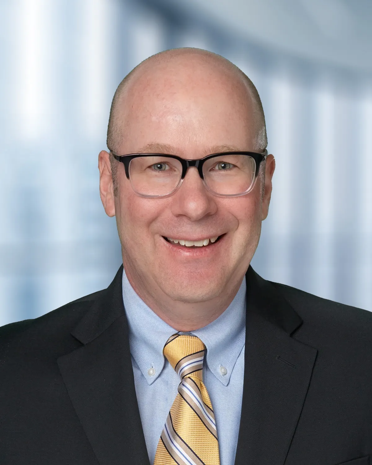 Headshot of a man in a suit.