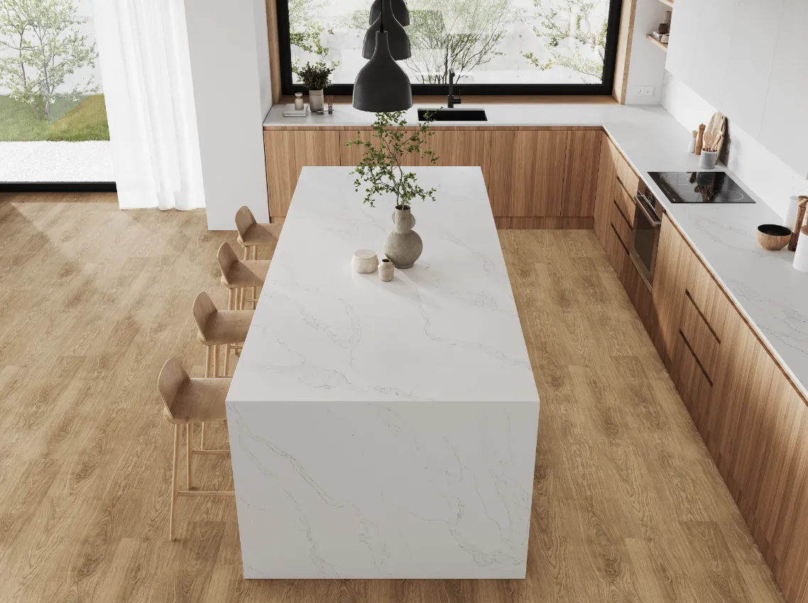 A kitchen with a white waterfall countertop island.