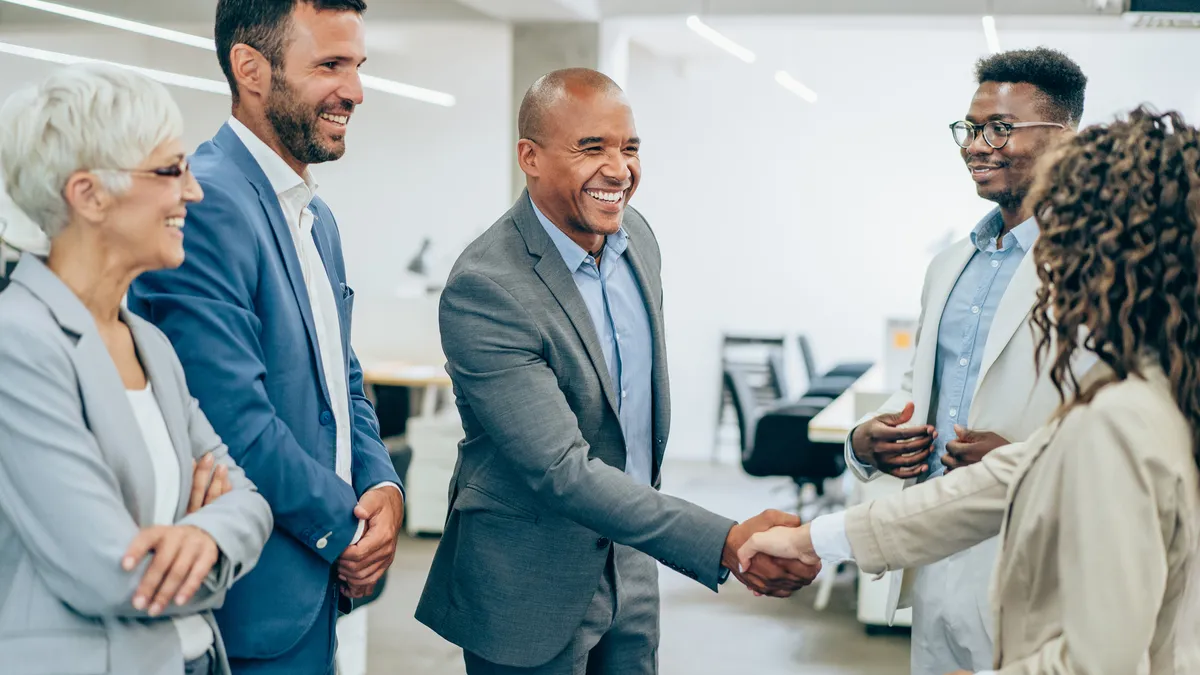 A new general counsel is introduced to their colleagues in an office setting