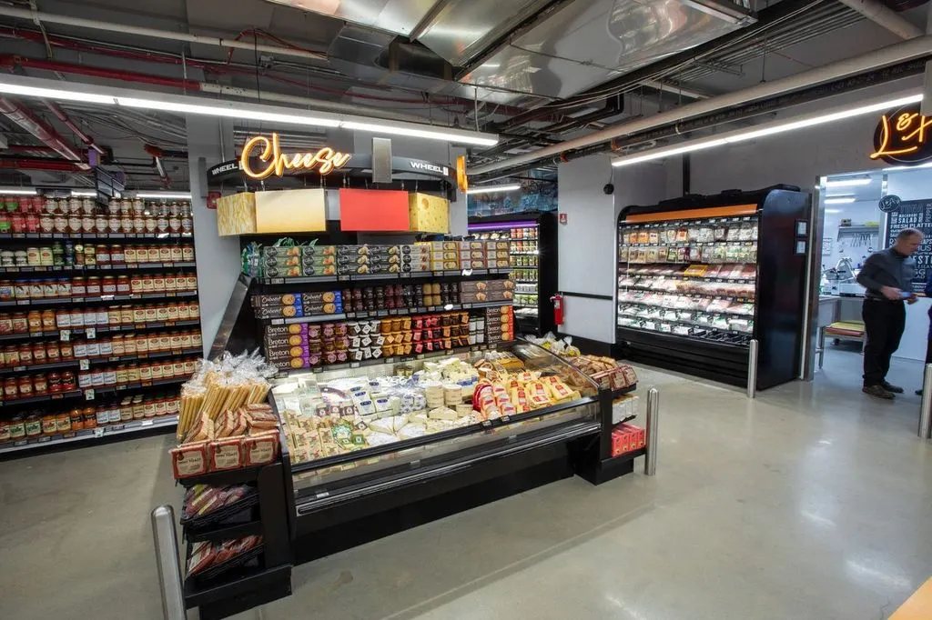 Cheese on display in a grocery store.