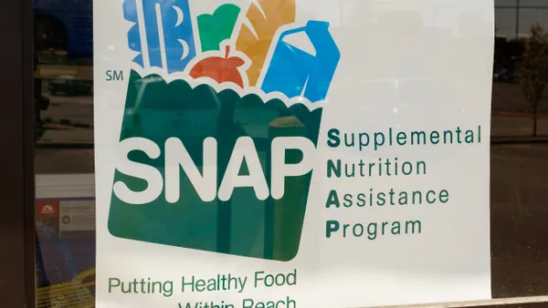 A sign in a window that says Supplemental Nutrition Assistance Program.
